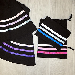 Character skirts, character skirt bags, dance shoe bags, skirts with pink ribbons, character purple ribbons.