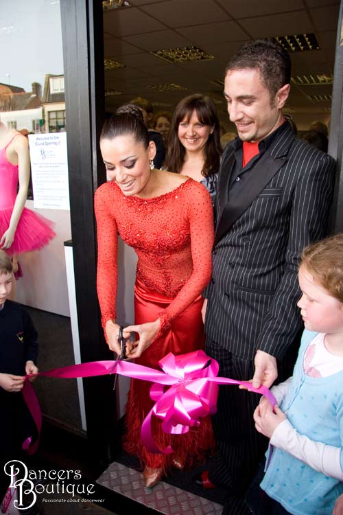 Lucy and Kieran hold the ribbon for Flavia. Dancers Boutique is officially opened